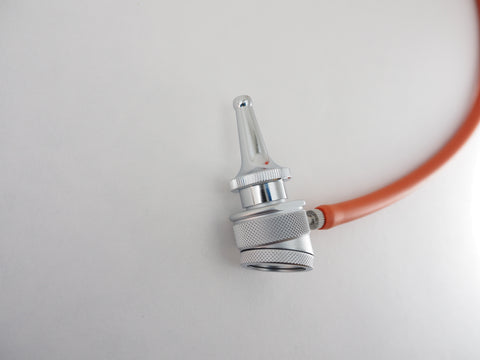 Close up of the Bruenings half lens diagnostic head with a tubing connector and a Bruenings Ear Specula. Used by Otolarygologists in surgical procedures and in office for diagnosis